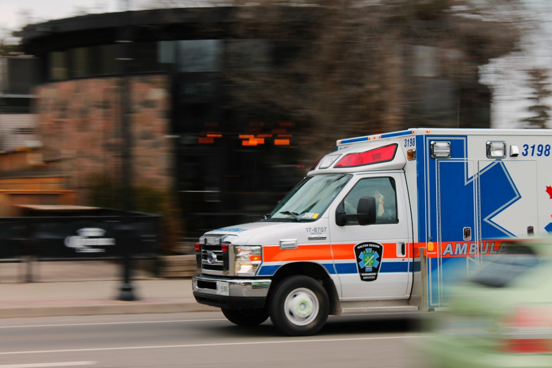 Ambulance responding through a community, illustrating public trust in emergency medical services